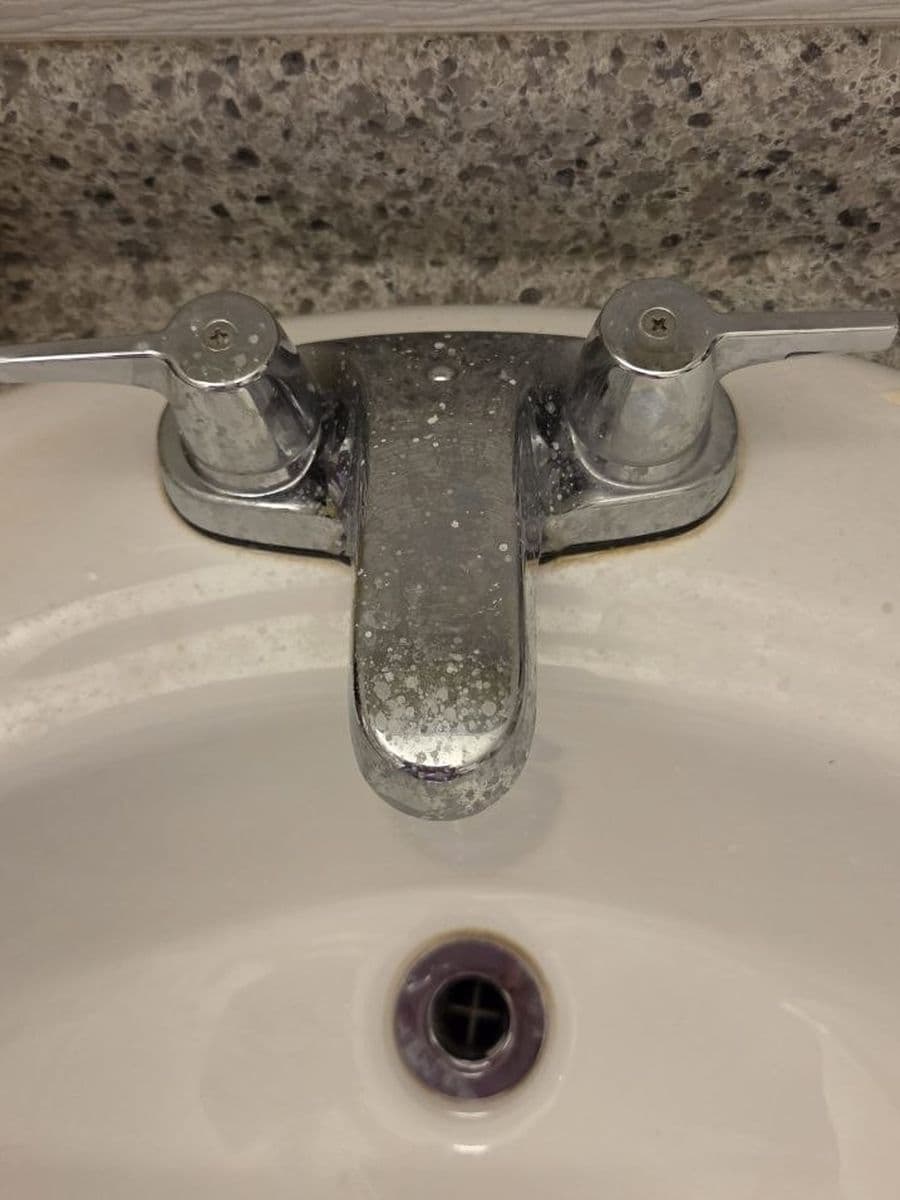 Hard water on chrome before cleaning by Red Deer House Cleaning