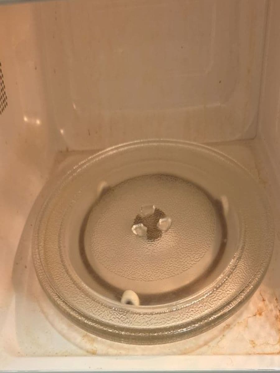 Inside the microwave before cleaning by Red Deer House Cleaning