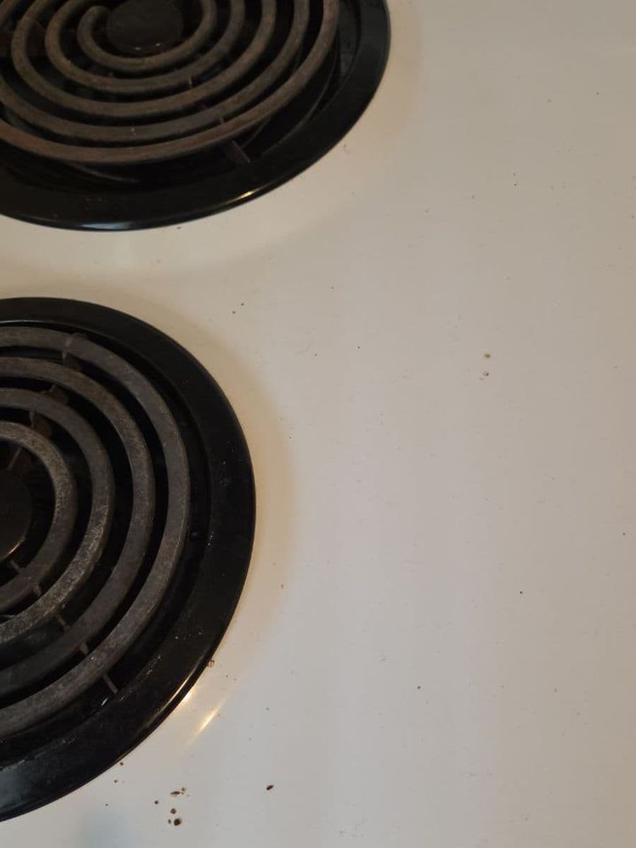 Stove top and drip pans before cleaning by Red Deer House Cleaning