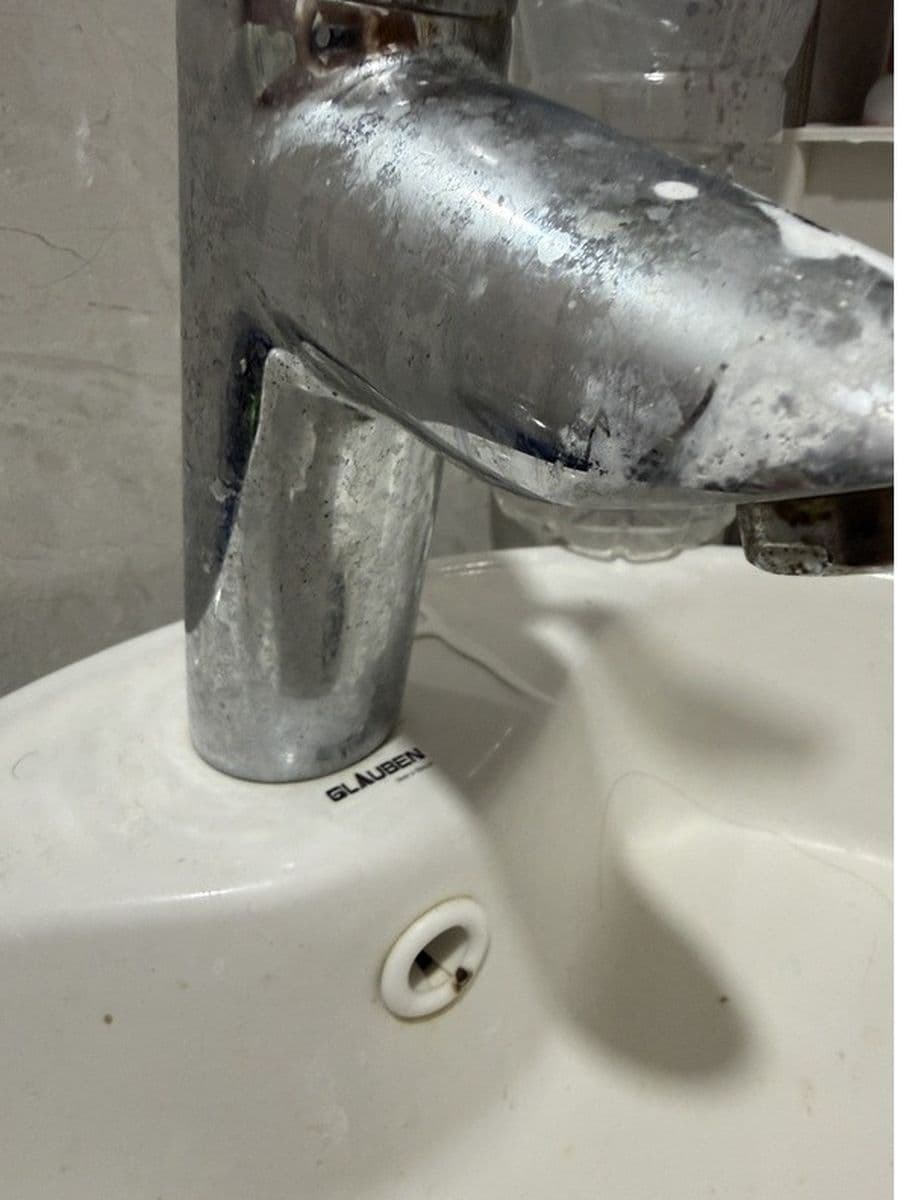 Chrome tap under heavy scale before cleaning by Red Deer House Cleaning