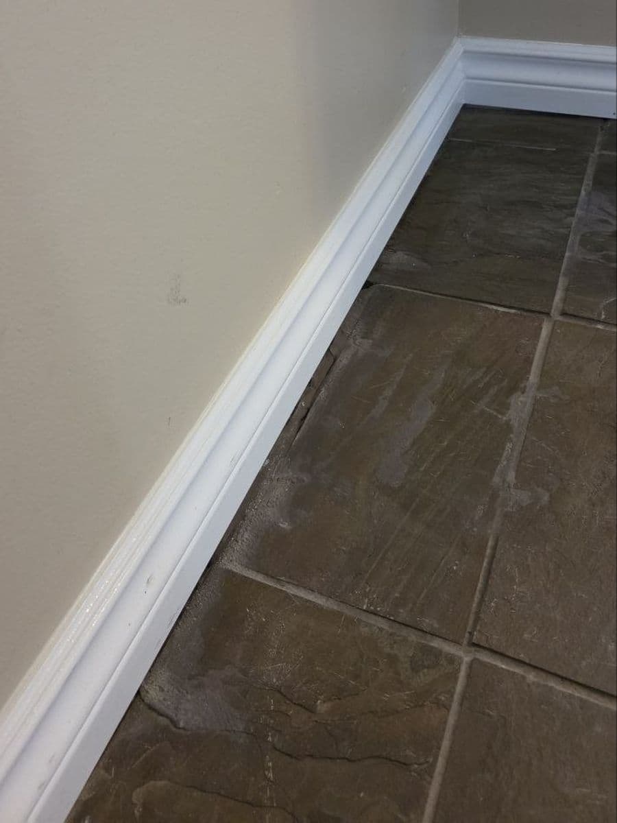 Tile floor, grout and baseboards after cleaning by Red Deer House Cleaning